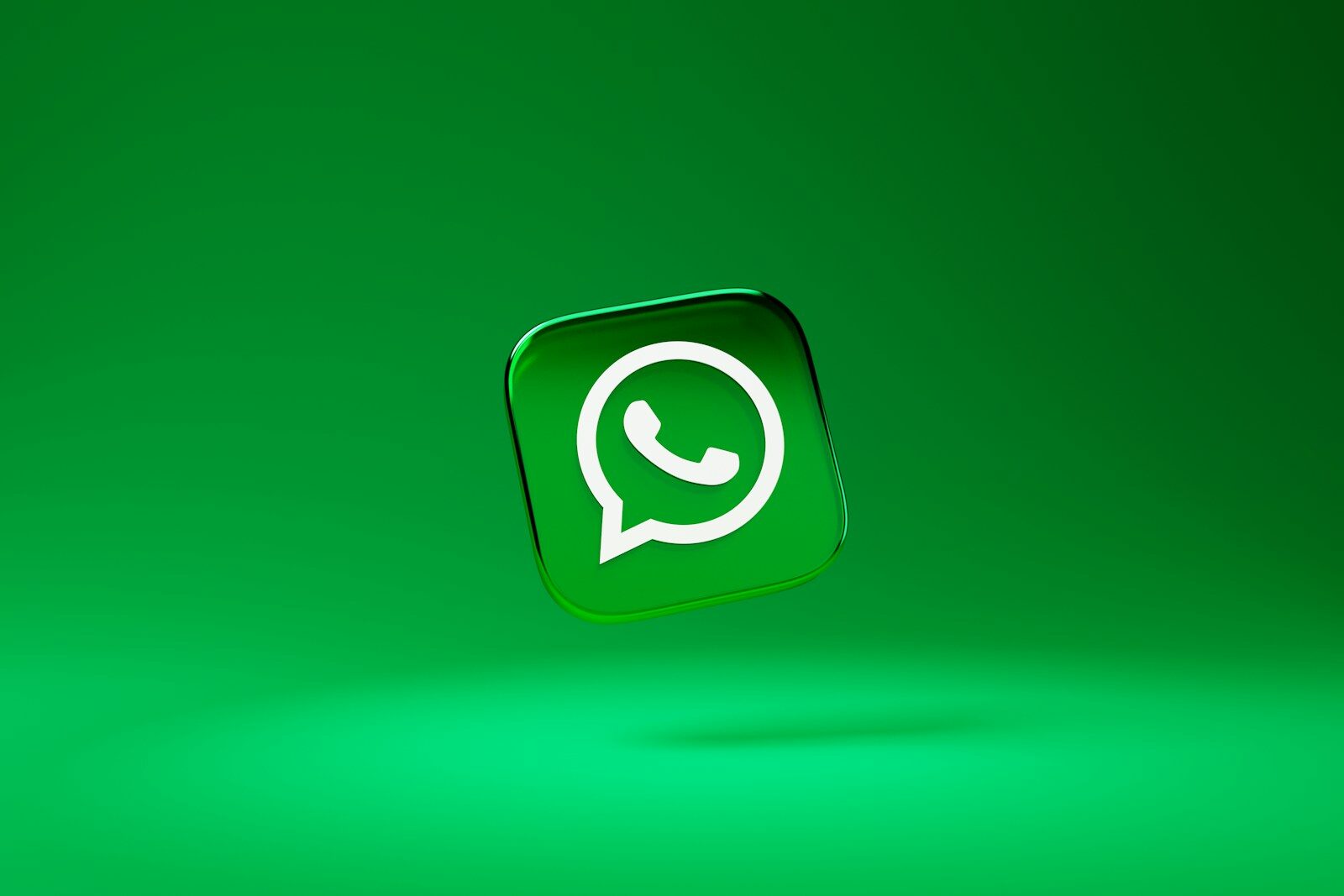 a glossy green square icon with a white telephone handset inside a speech bubble